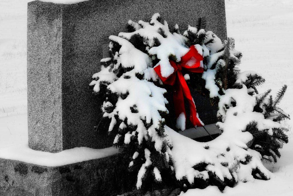 A wreath leaning against a gravestone